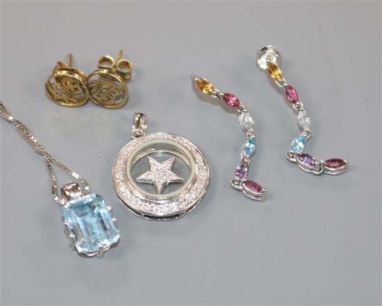 An 18ct white gold and diamond spinning star pendant, a 9ct white gold and aquamarine pendant on chain and and two pairs earrings